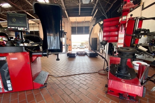 EurAuto Shop in Plano Tx, state of the art alignment machines that are red in color ready to be attached to service a customer vehicle