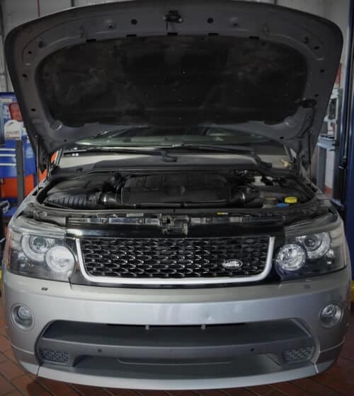 EurAuto Shop in Plano Tx, land rover repair and service; a silver land rover that was just serviced with hood open in service bay