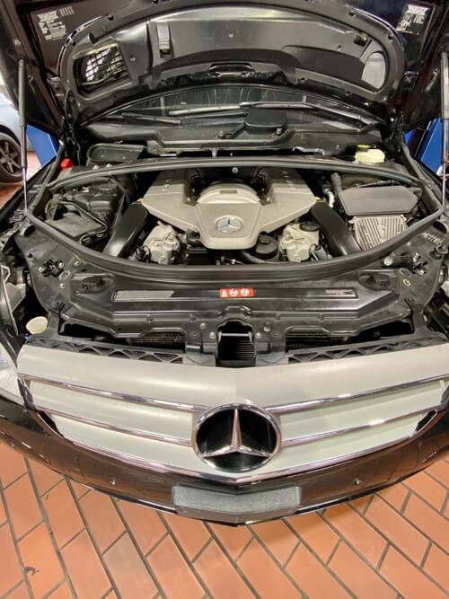 EurAuto Shop in Plano, Tx has a black Mercedes sedan with hood open for showing motor mercedes repair and service