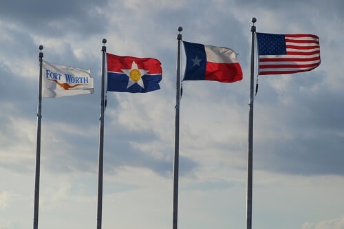 Auto Repair in Dallas/Ft. Worth Tx at EurAuto Shop, Plano. Tx. image of Ft. Worth, Dallas, Texas and American flags on poles