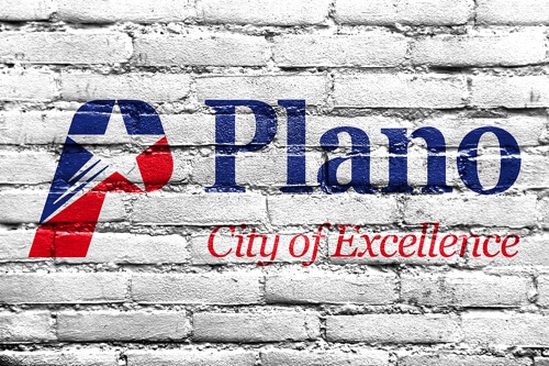 Areas we serve at EurAuto Shop, Plano Tx. image of Plano City of Excellence symbol and words painted in blue and red on a white brick wall
