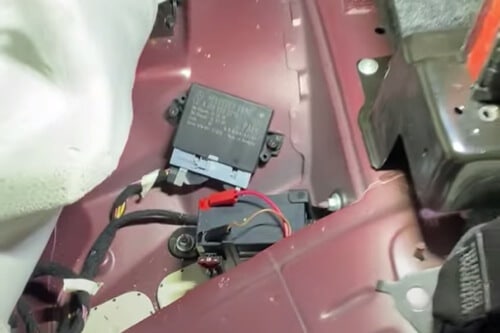 Fixing the “Auxiliary Battery Malfunction” Warning in a Mercedes with EurAuto Shop in Plano Tx. image of area in mercedes where the aux battery is found, under the 2nd row seating