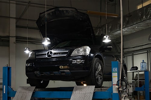 7 Things That Can Your Void Your European Car Warranty | EurAuto in Plano TX., Image of Used black car Mercedes Benz GL Open hood for preventive maintenance