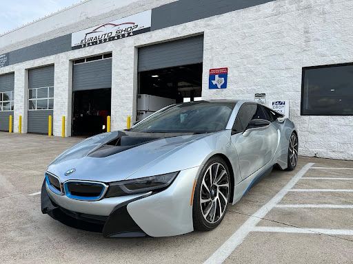 European auto repair specialists near me in Plano, TX with EurAuto Shop. Image of newer model silver 2 door BMW sports car parked outside of our shop bay doors and signage.