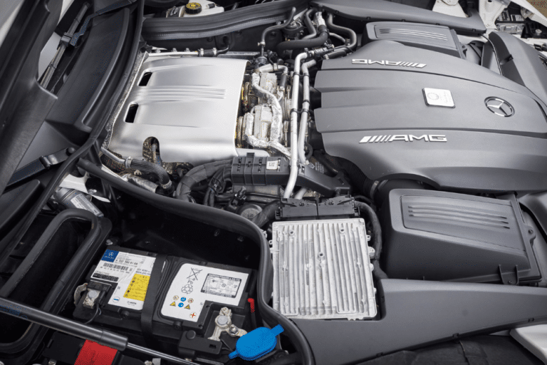 Auxiliary battery issue, European auto repair in Plano, TX at EurAuto Shop. Mercedes-AMG engine bay with a visible auxiliary battery.