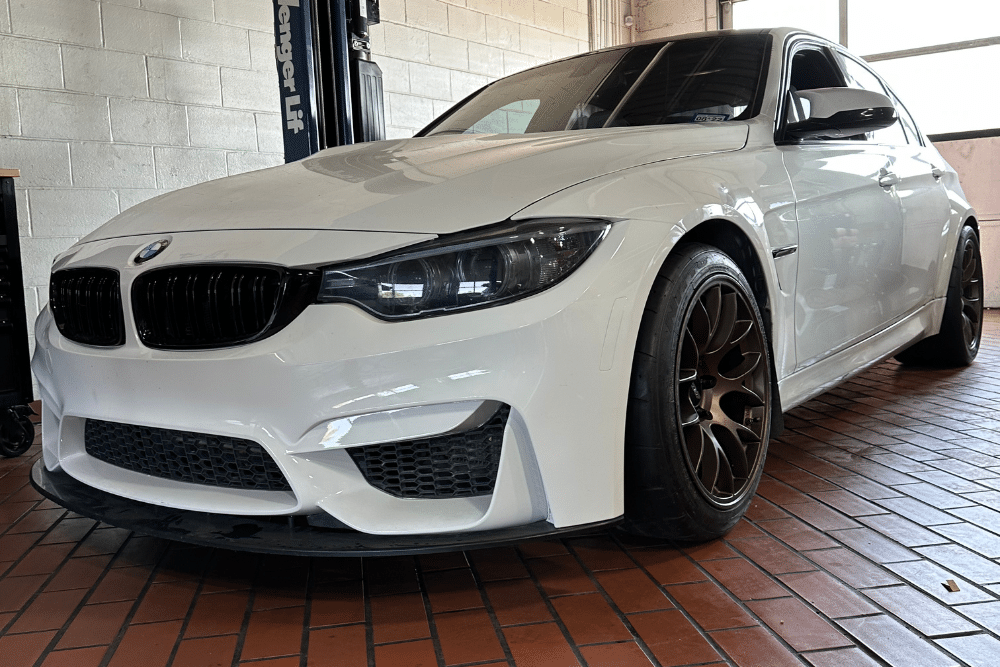 BMW Maintenance, european auto repair in Plano, TX at EurAuto Shop. A white BMW sports sedan in a professional auto repair shop.