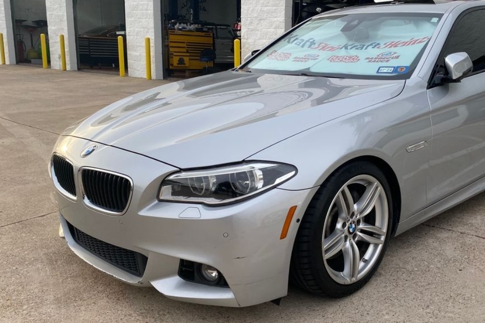 BMW Maintenance in Plano TX At EurAuto Shop. Silver BMW parked outside a professional auto repair shop for maintenance