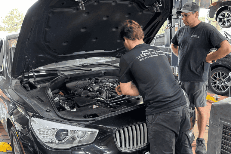 Auto A/C repair in Plano, TX by EurAuto Shop. Image of a technician inspecting a European vehicle A/C system with diagnostic equipment.