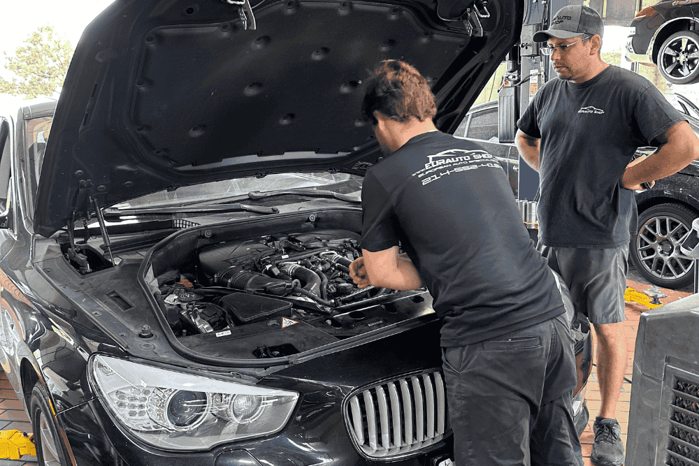Auto A/C repair in Plano, TX by EurAuto Shop. Image of a technician inspecting a European vehicle A/C system with diagnostic equipment.