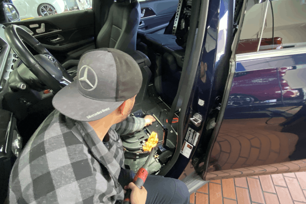 How Texas Heat Damages Batteries in European Cars in Plano, TX by EurAuto Shop. Image of a technician testing a European car battery with factory diagnostic tools.