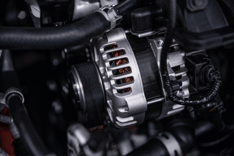 Alternator failure, auto repair in Plano, TX, at EurAuto Shop. A close-up image of a vehicle alternator inside the engine bay, highlighting a key charging system component inspected during professional alternator diagnosis and electrical system repair.