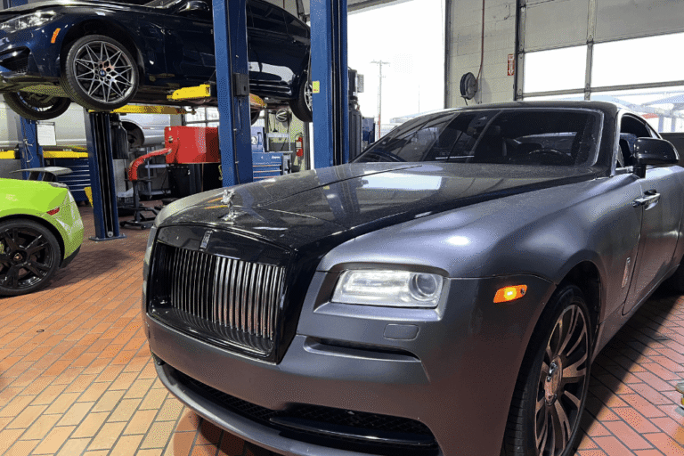 Car A/C issues, European auto repair in Plano, TX, at EurAuto Shop. An image of a Luxury Rolls-Royce inside a European auto repair shop specializing in premium vehicle maintenance and repair, with BMW and Lamborghini vehicles visible in the service bays.