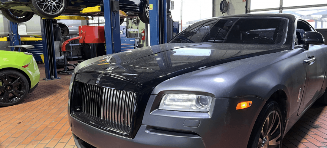 Car A/C issues, European auto repair in Plano, TX, at EurAuto Shop. An image of a Luxury Rolls-Royce inside a European auto repair shop specializing in premium vehicle maintenance and repair, with BMW and Lamborghini vehicles visible in the service bays.